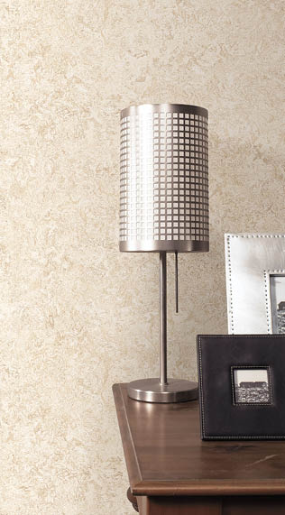 Night table with lamp, frames and beige textured wallpaper