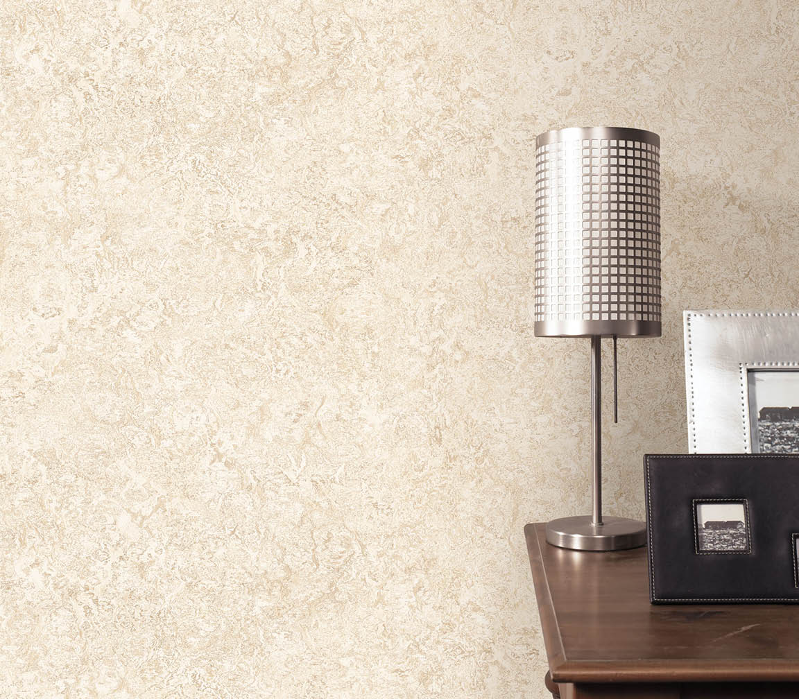 Night table with lamp, frames and beige textured wallpaper